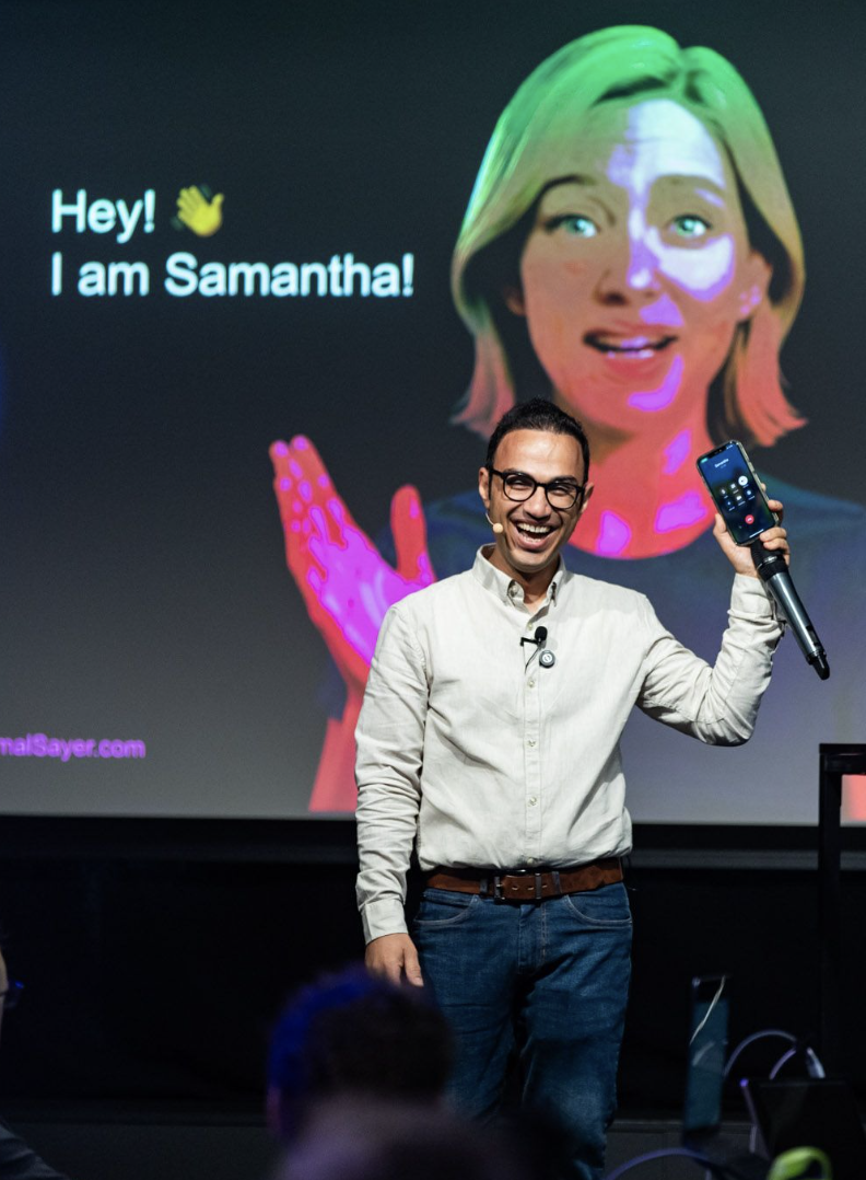 Aemal celebrating the successful Samantha voice AI demo while holding his phone