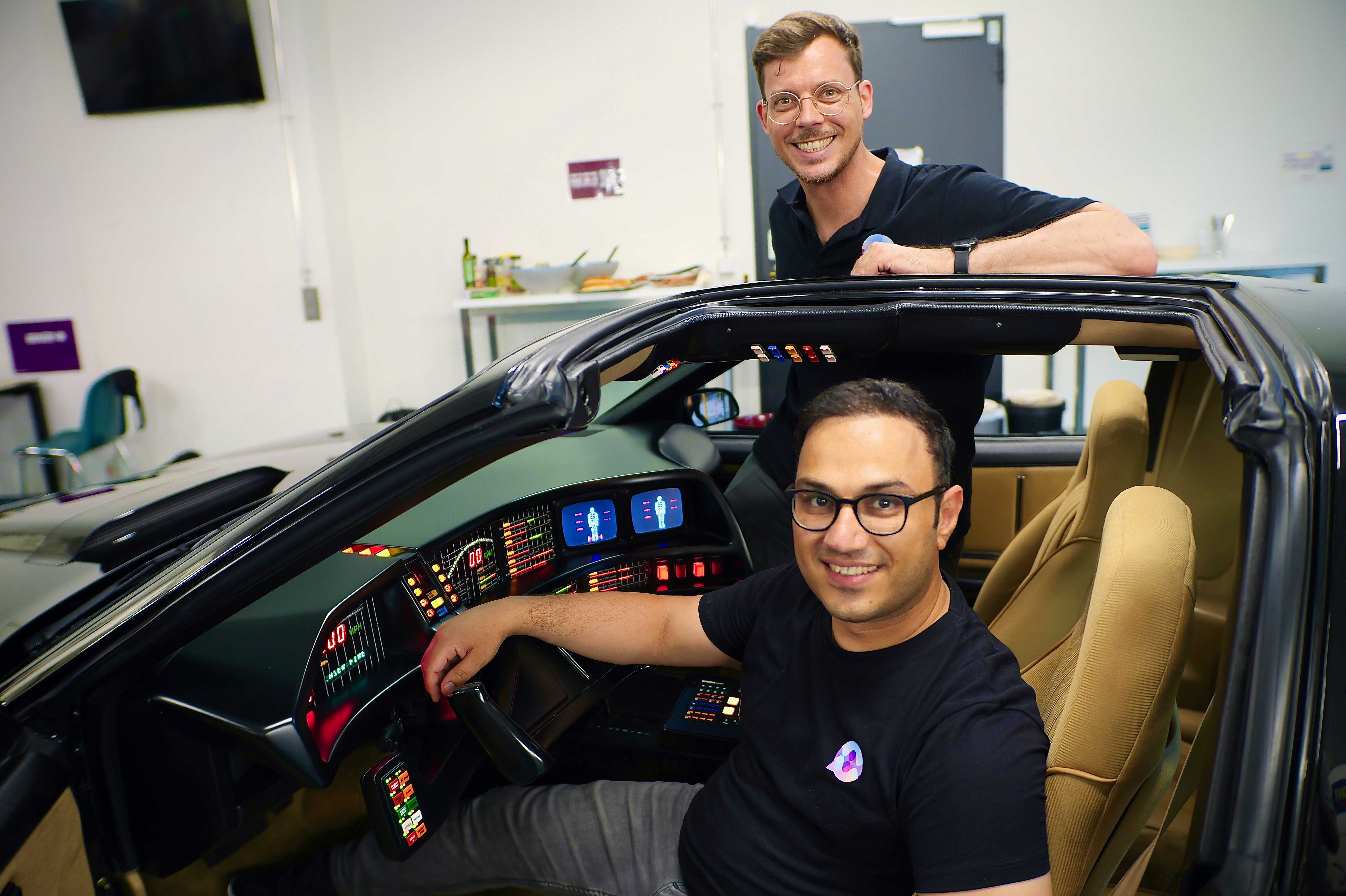Aemal and his cofounder Alex with the KITT car from Knight Rider